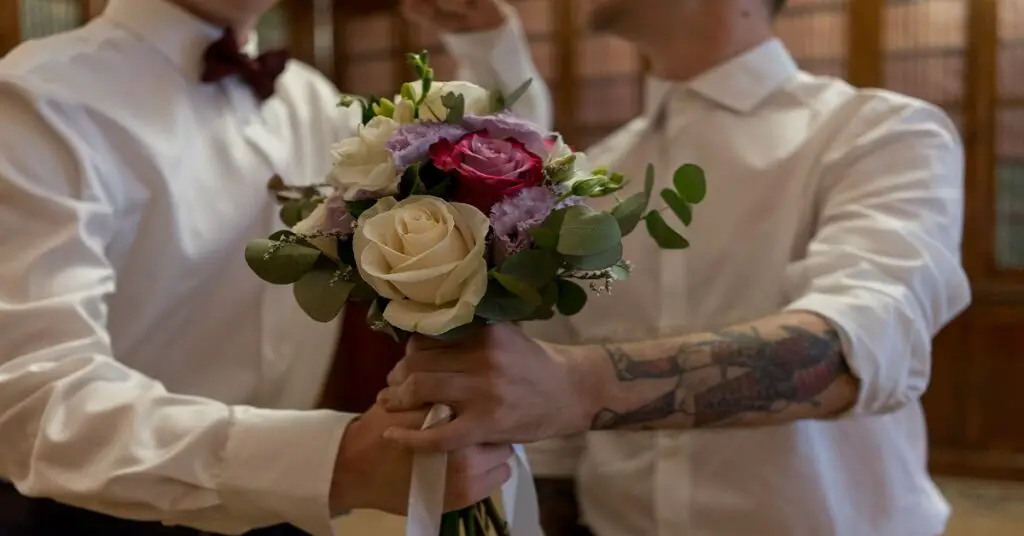 two guys getting married holding flowers